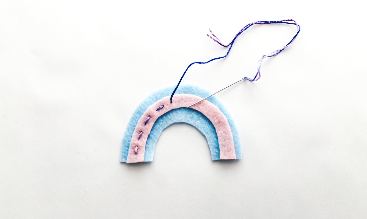 stitching center stripe on rainbow felt ornament