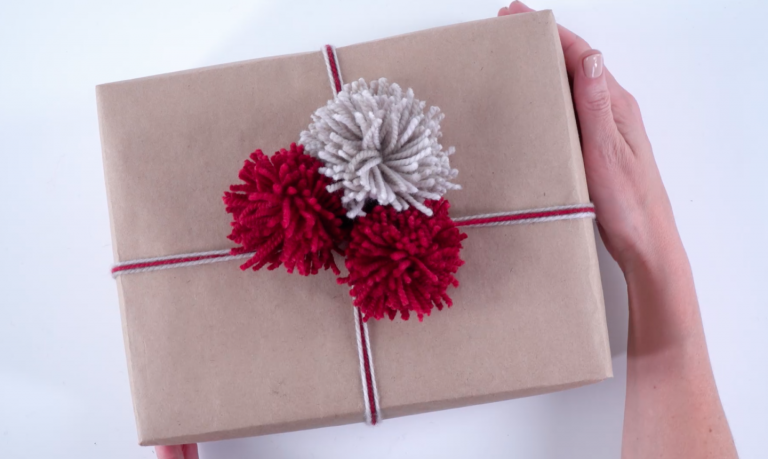 gift wrapped with yarn pom poms