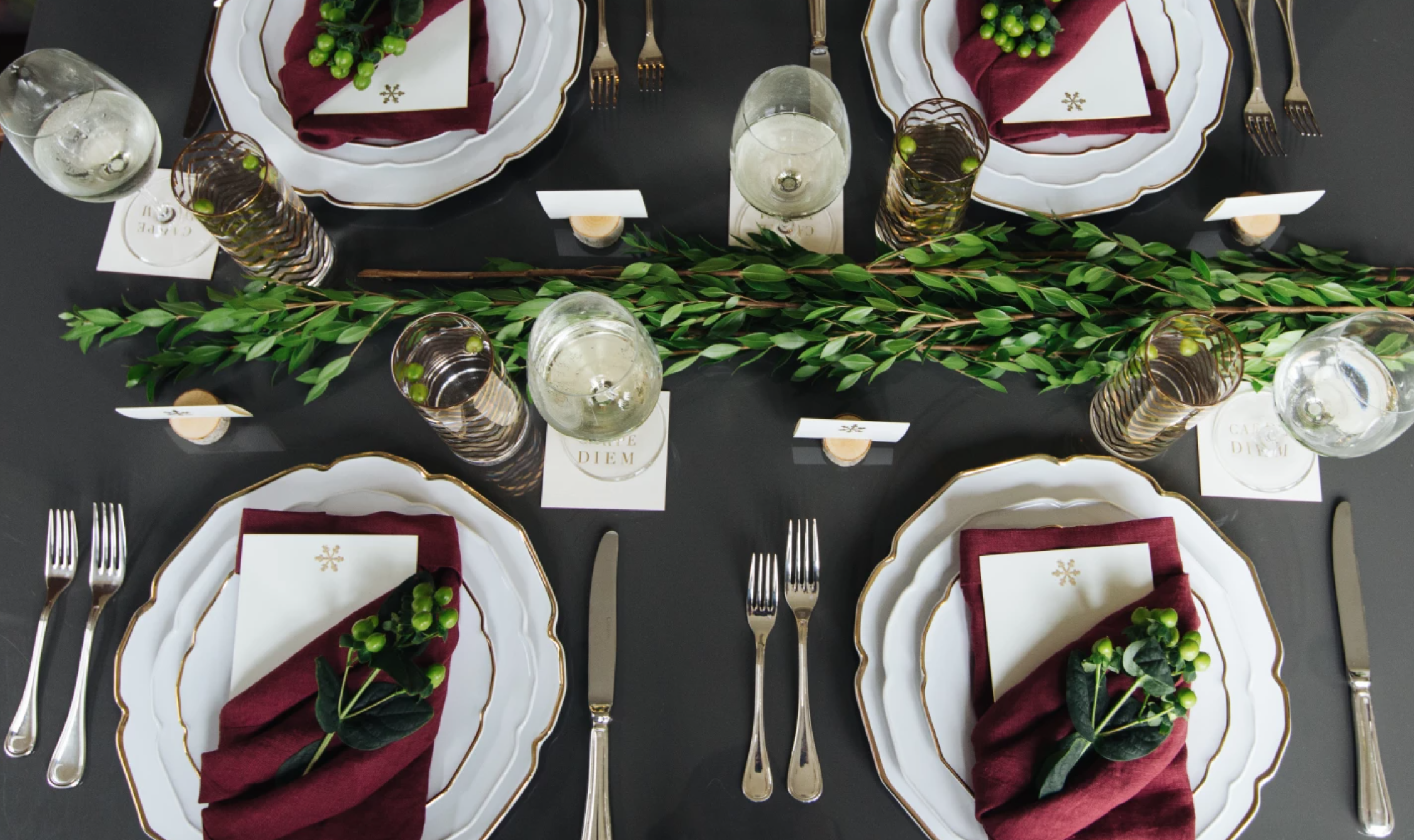 holiday table with white plates and red napkins