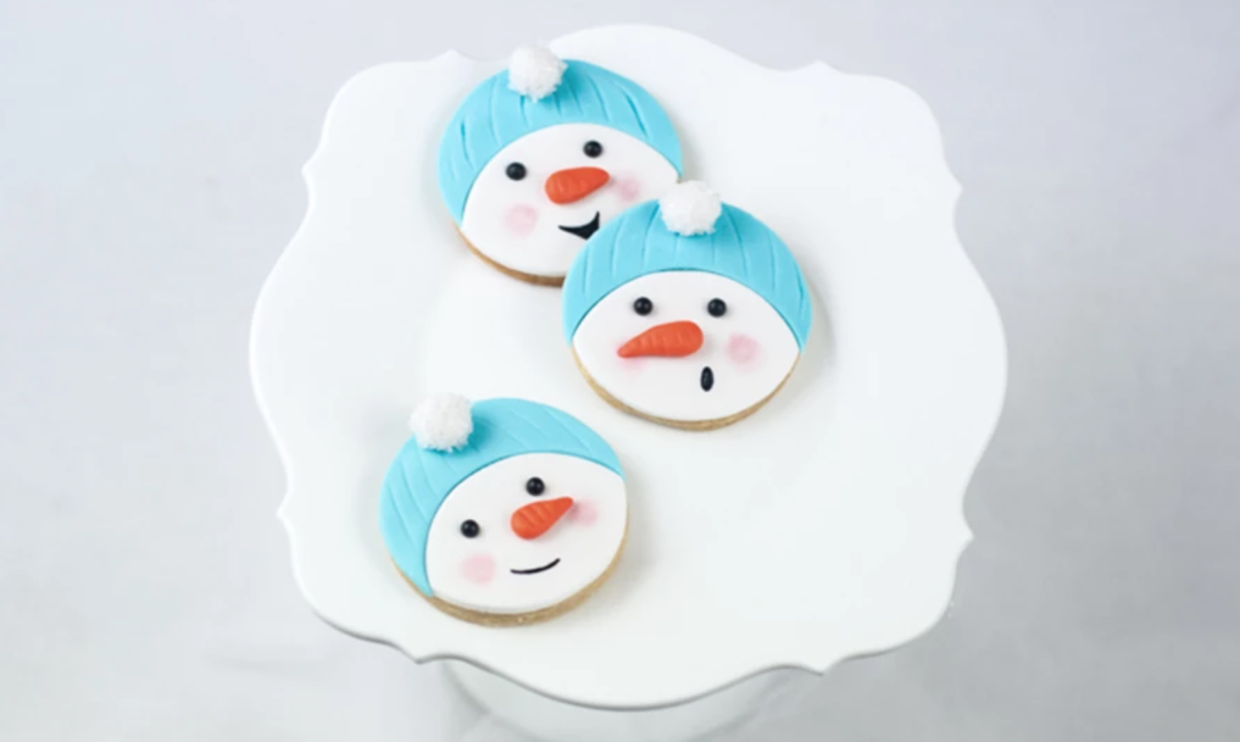 snowman cookies on a white plate