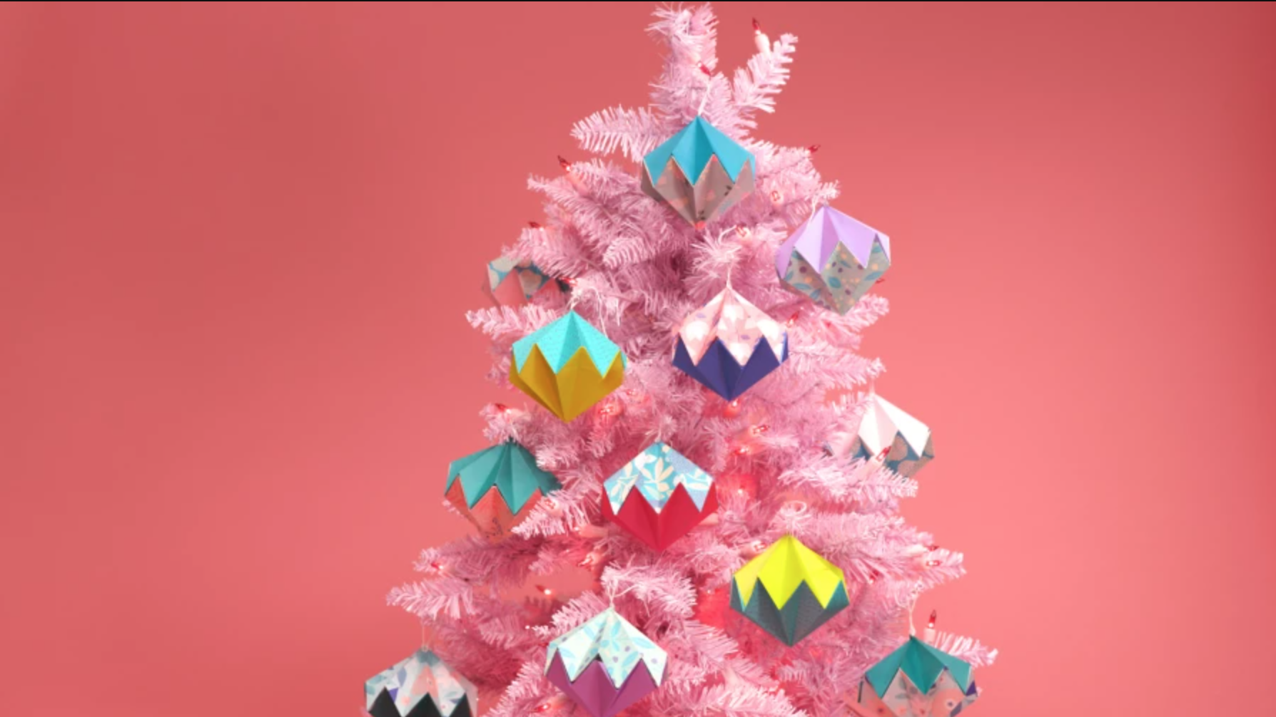 origami ornaments on a pink tree