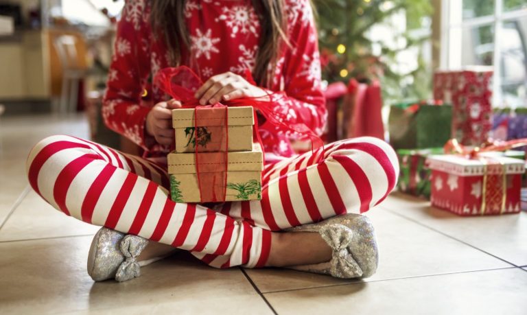 girl holding wrapped christmas present