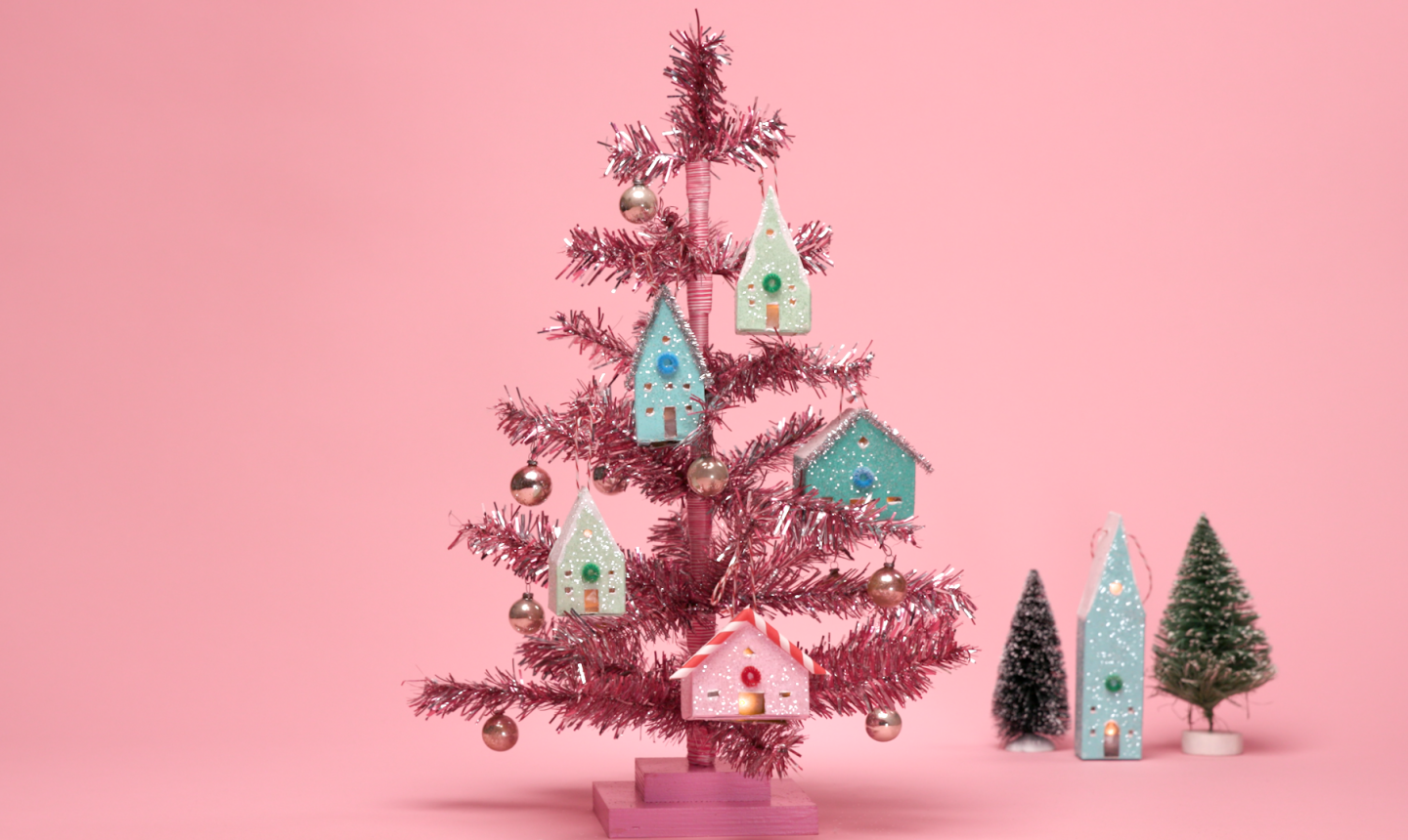 light up house ornaments on pink tree