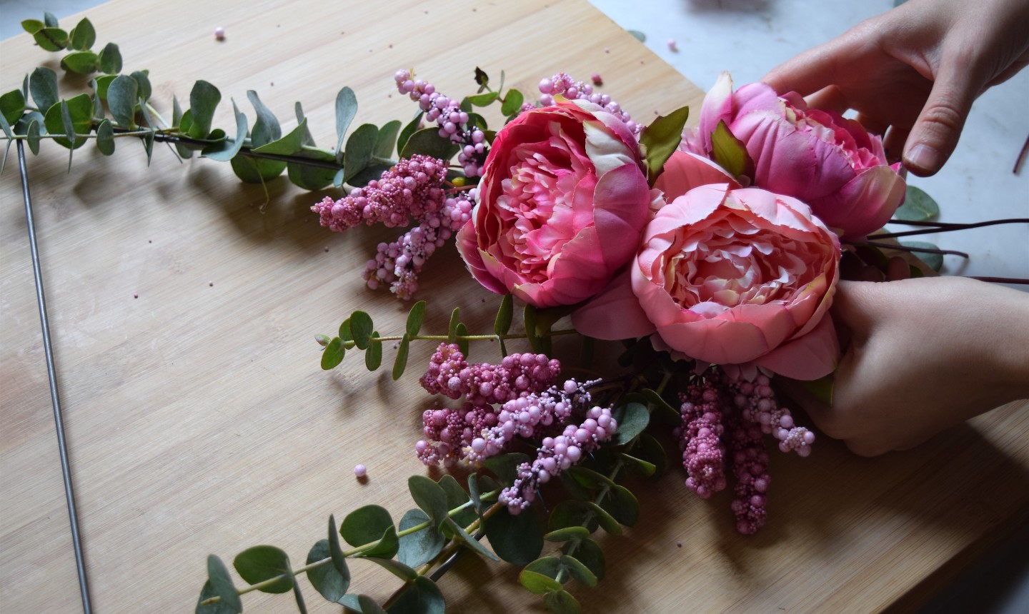 adding flowers to triangle wreath