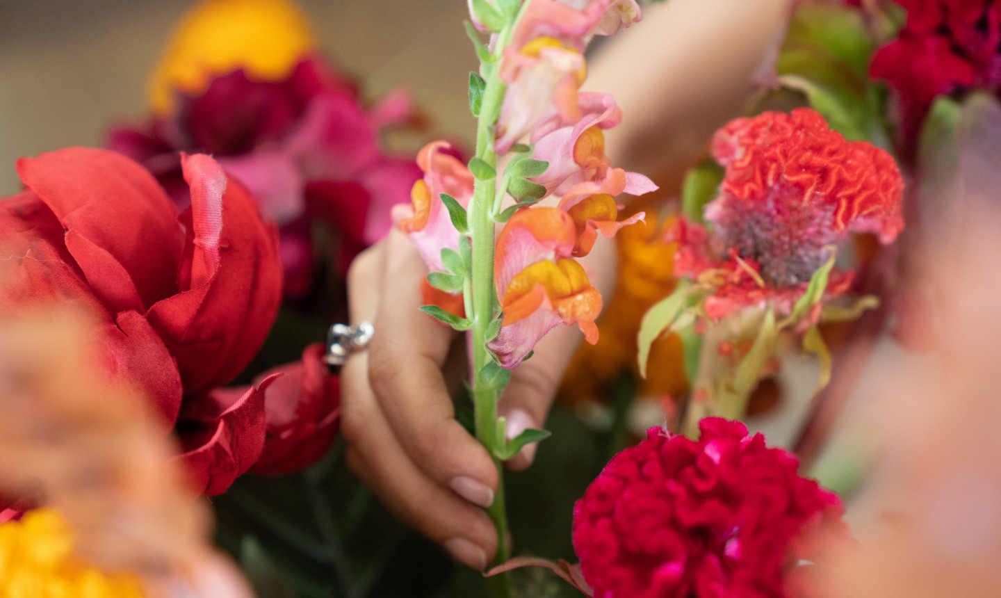 adding flowers to centerpiece