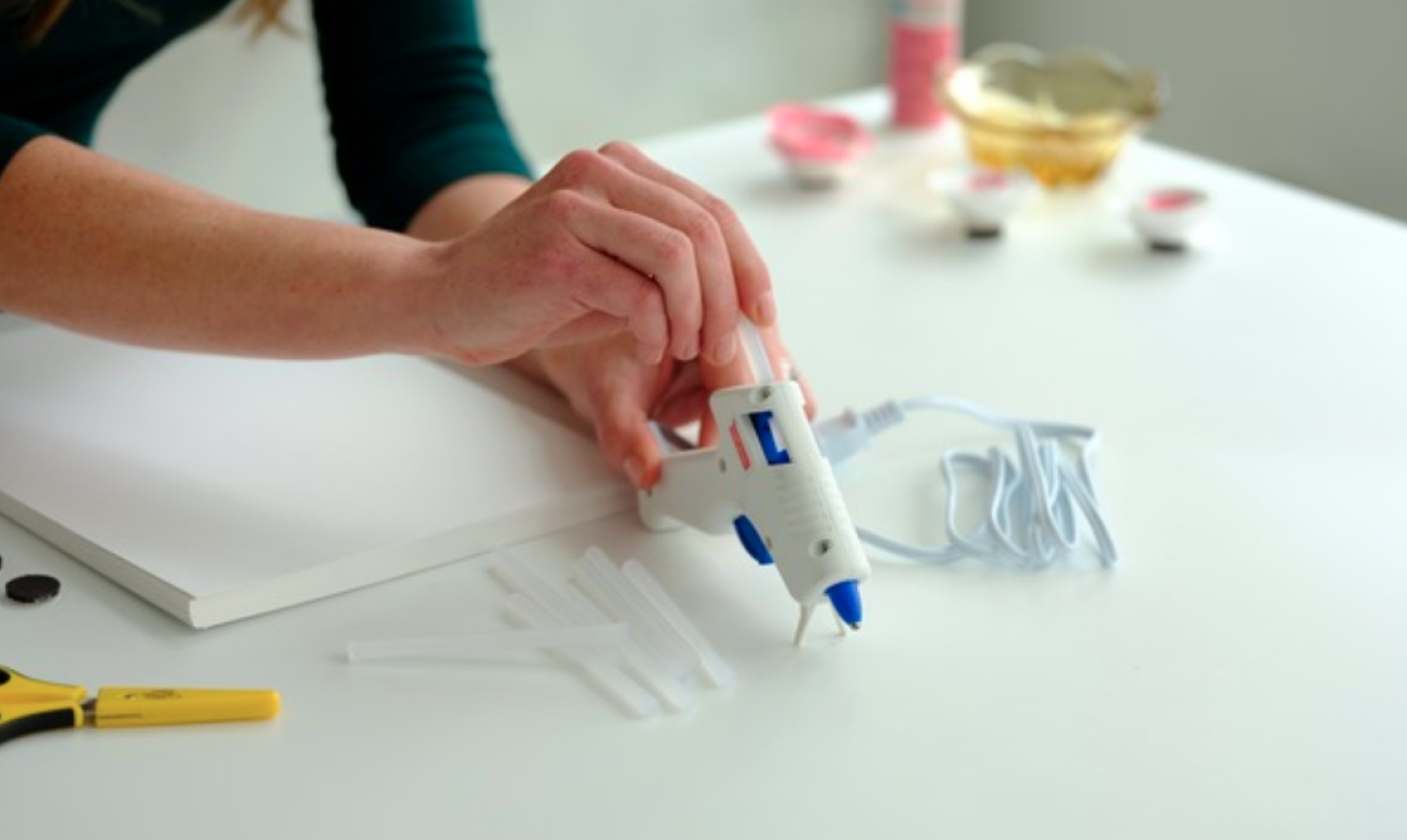 woman using hot glue gun