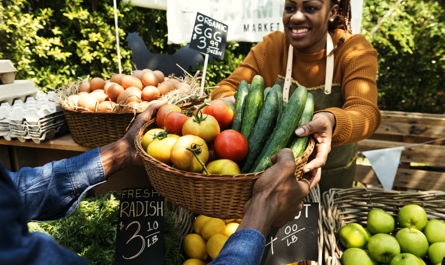 woman selling veggies at farmer's market