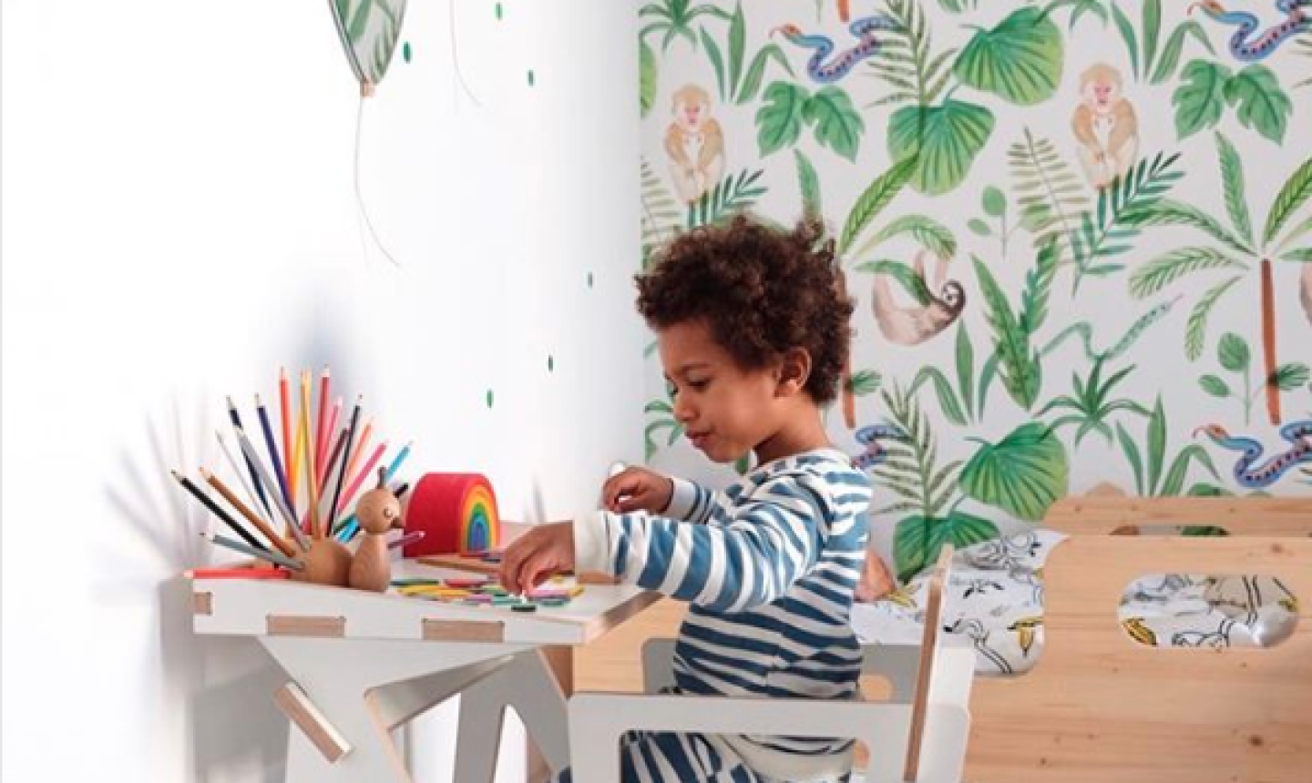 kid crafting with wallpaper in background