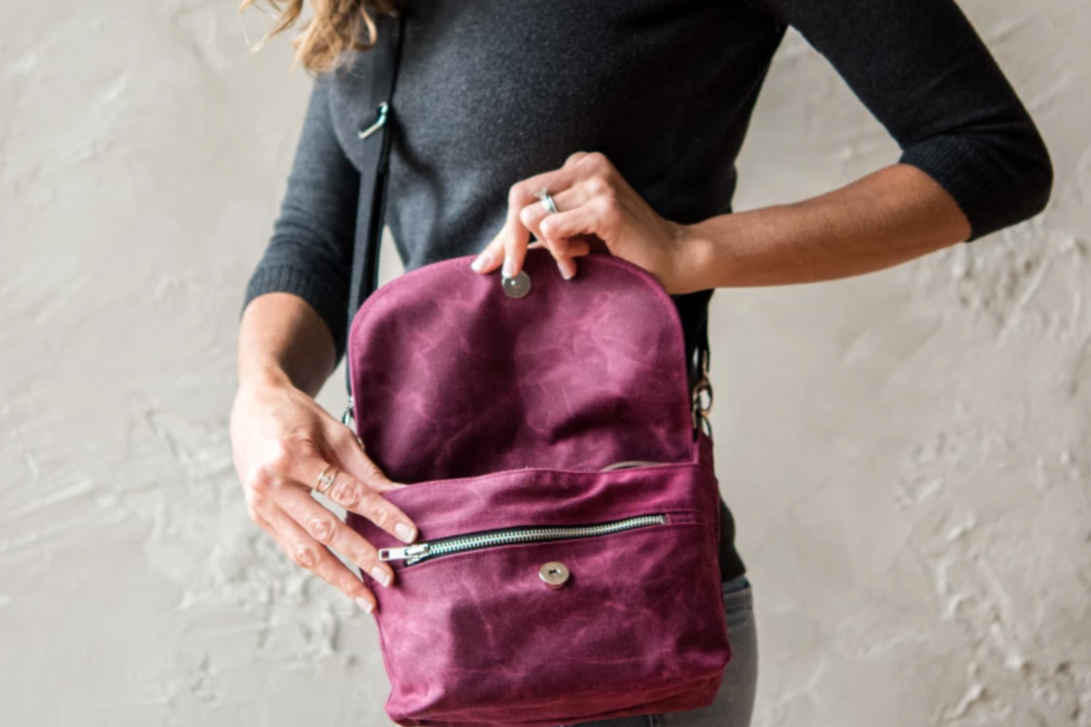 woman holding waxed canvas bag