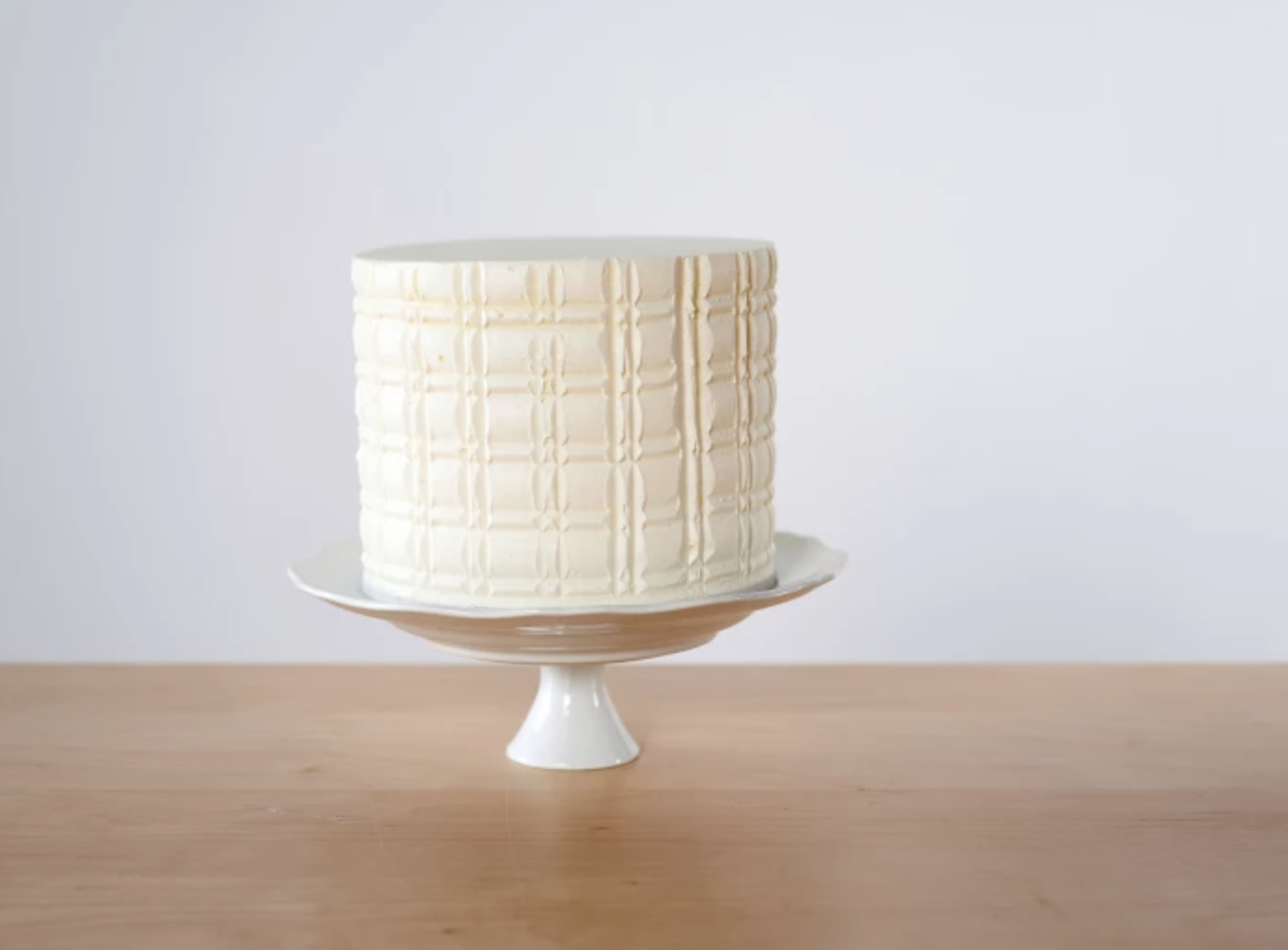 combed white cake on stand