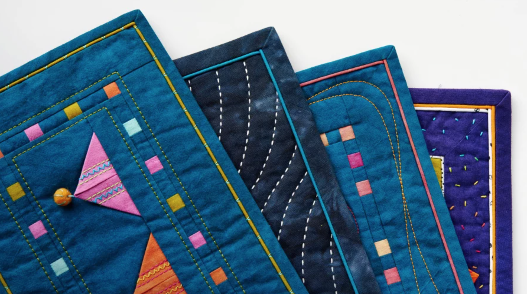 bound blue quilts fanned out