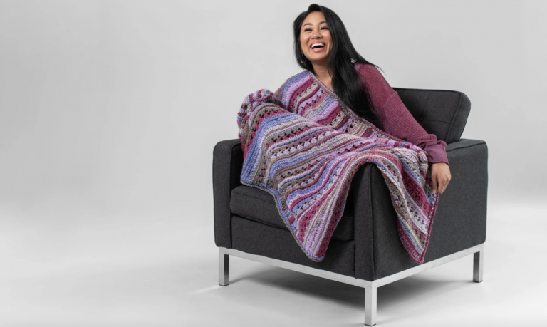 woman with purple crochet blanket
