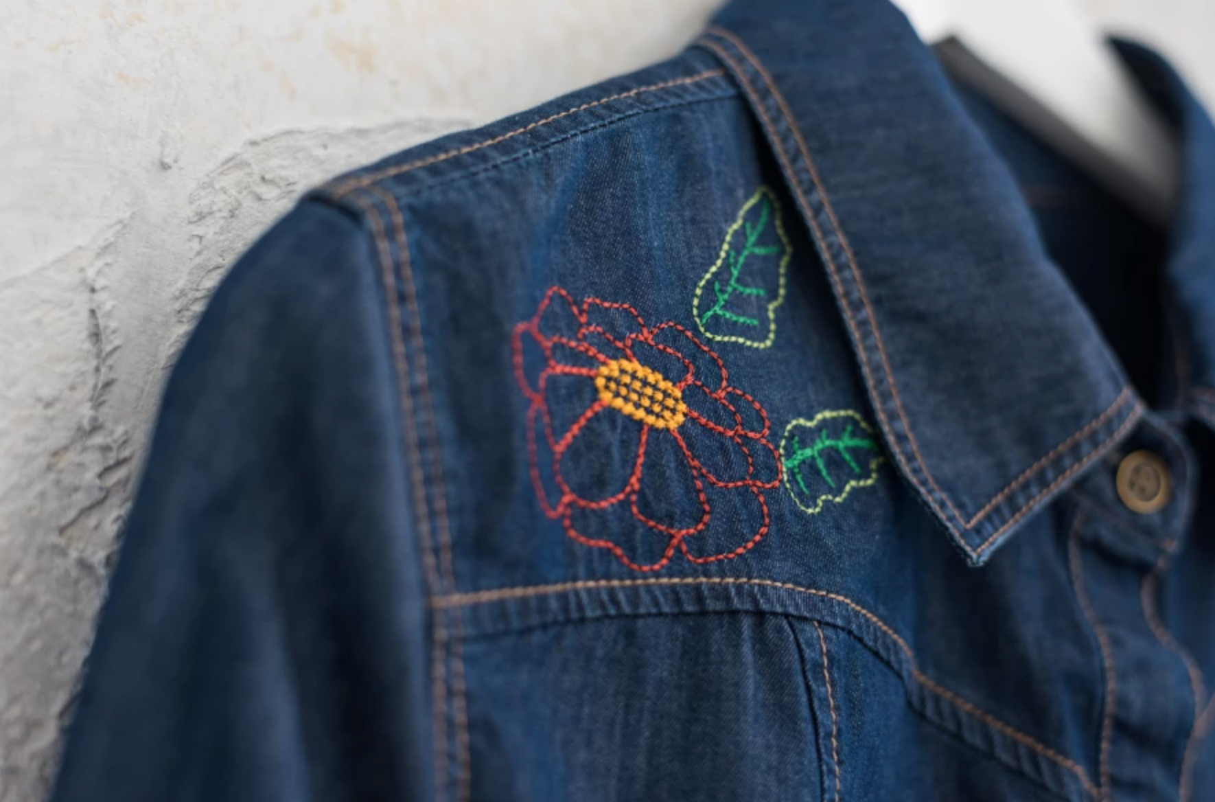 machine embroidered flower on denim