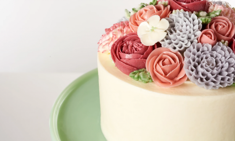 white cake with piped flowers on top