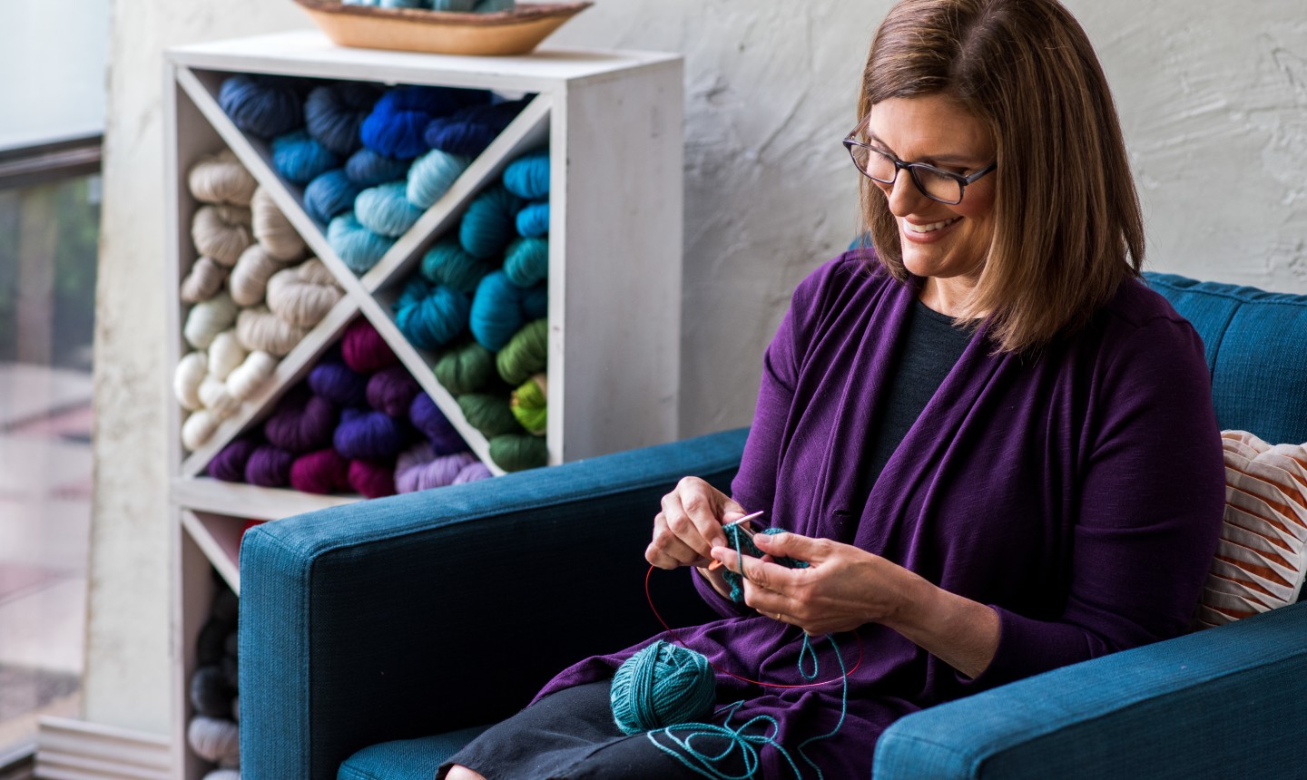 woman knitting in chair