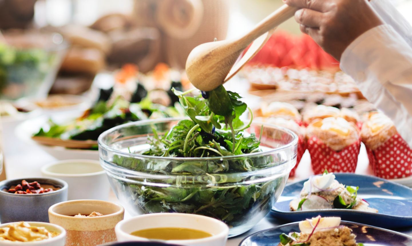 woman tossing salad at dinner