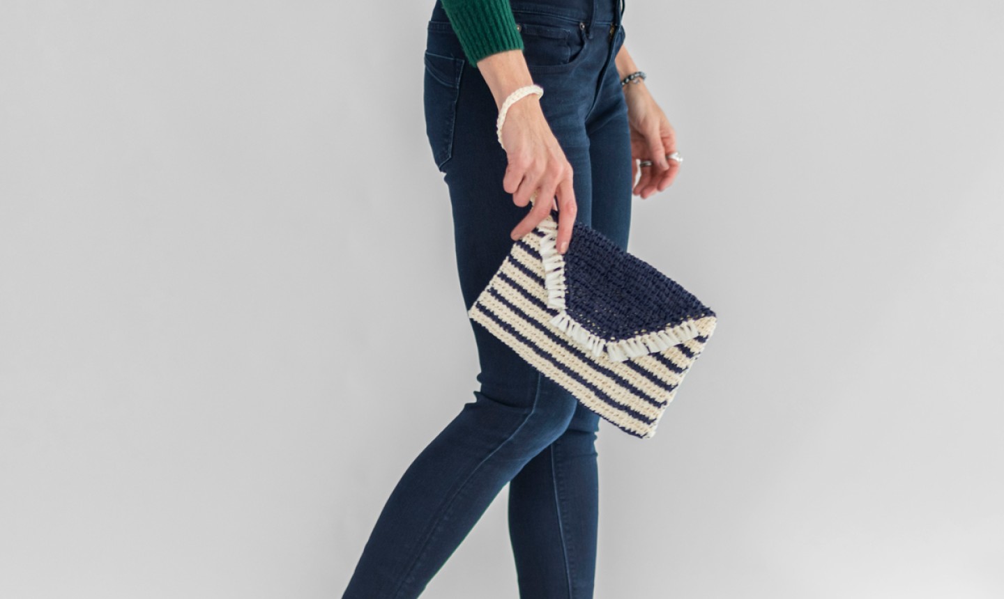 woman holding tunisian crochet clutch