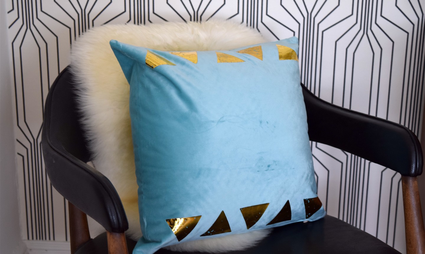 gold triangle pillow on chair