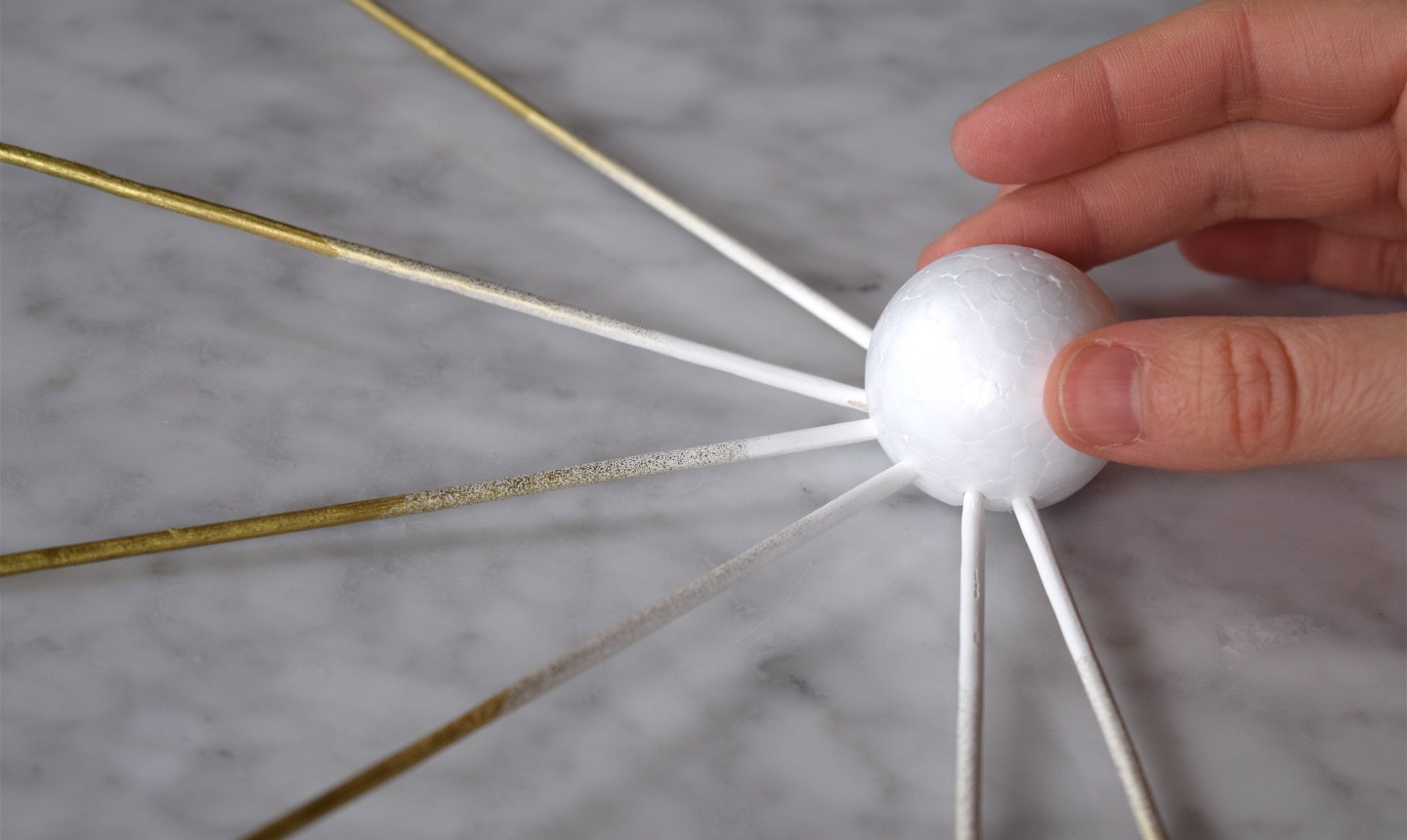 placing skewers into styrofoam ball