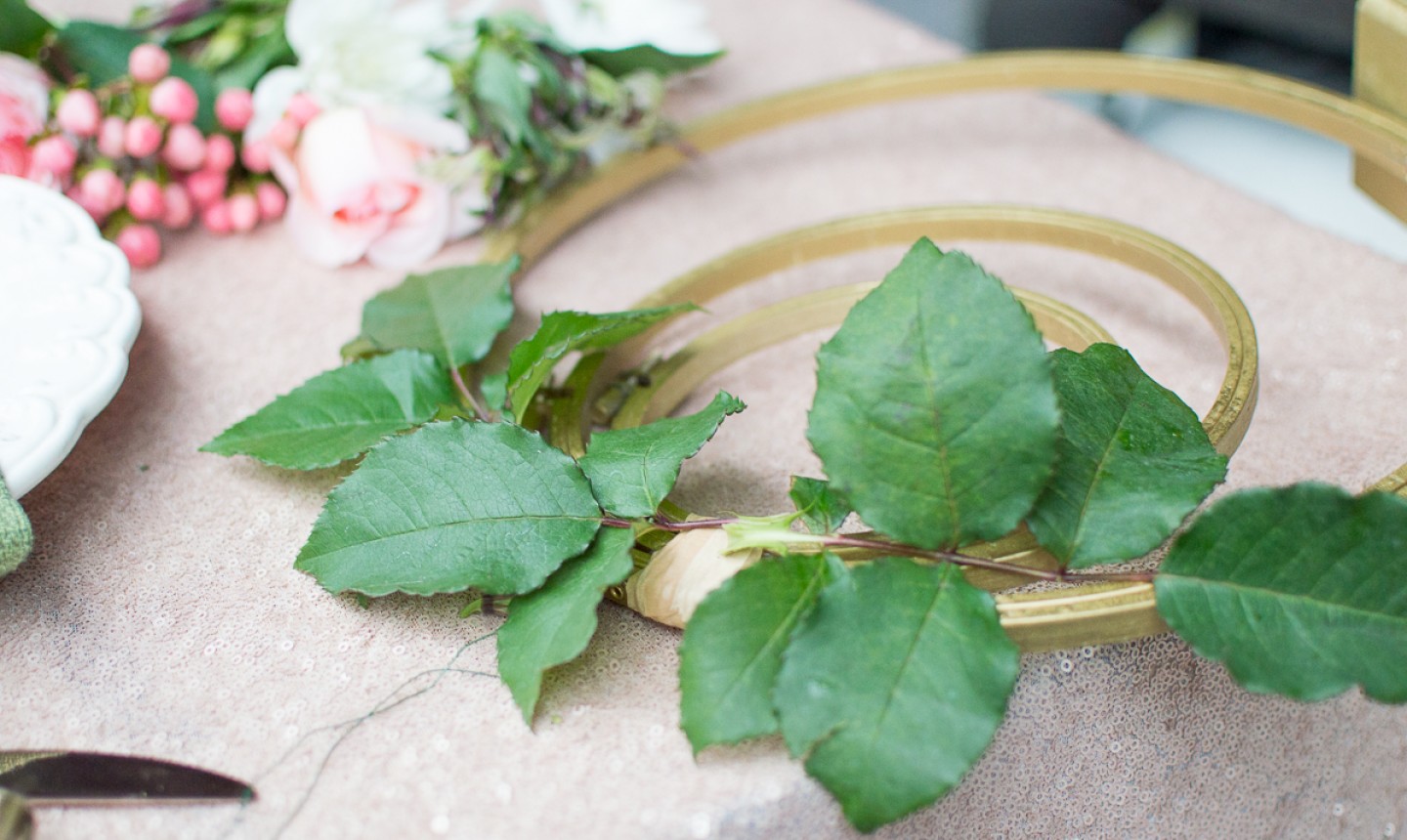 adding greenery to embroidery centerpiece