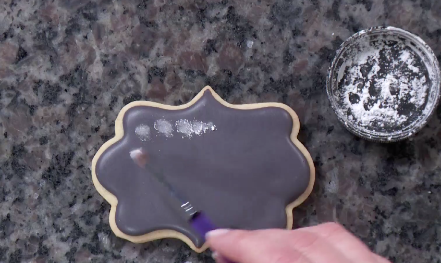 painting chalky royal icing on cookie
