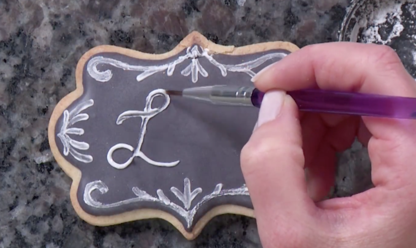 painting words on chalkboard cookie