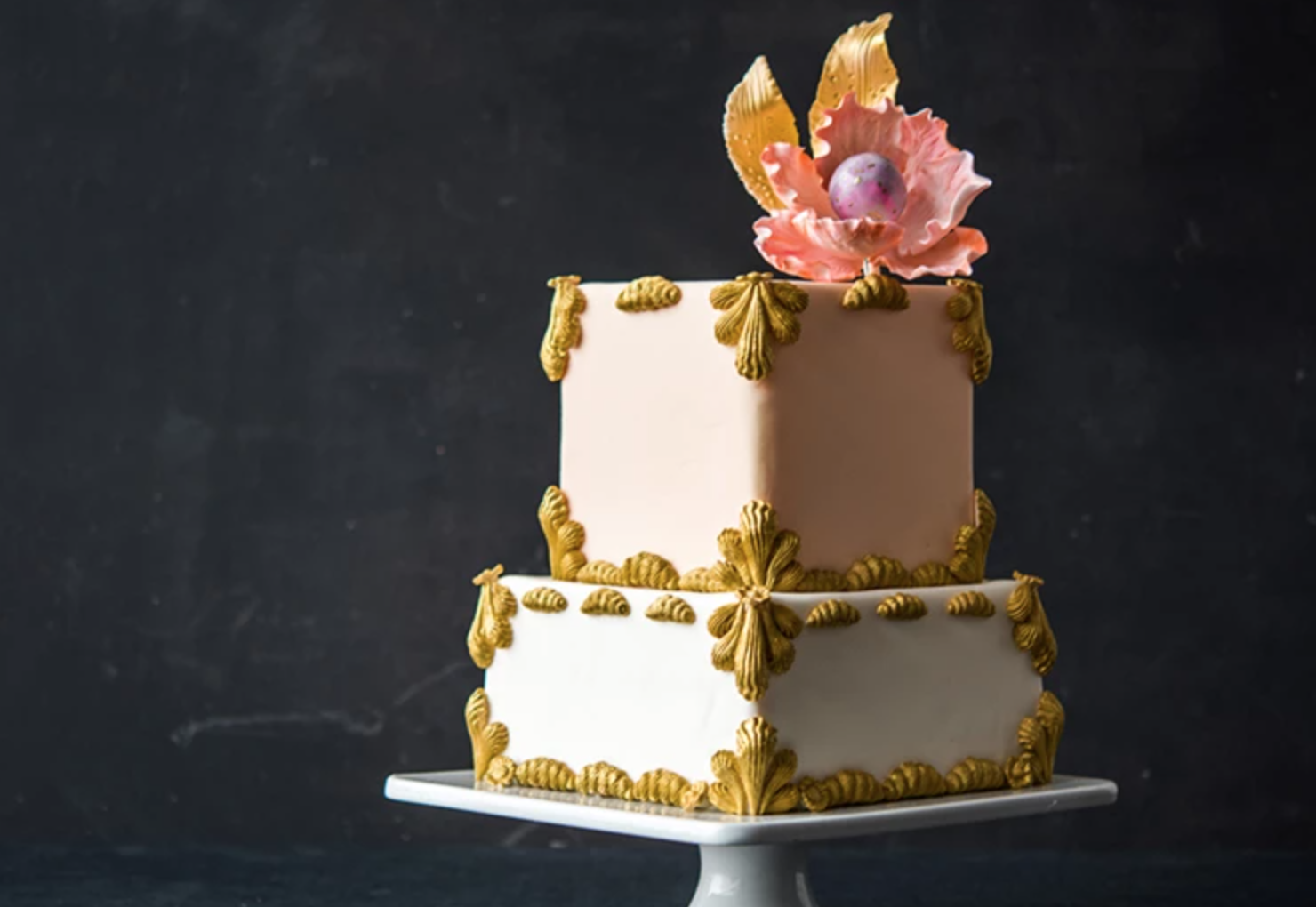 tiered square cake with gold accents