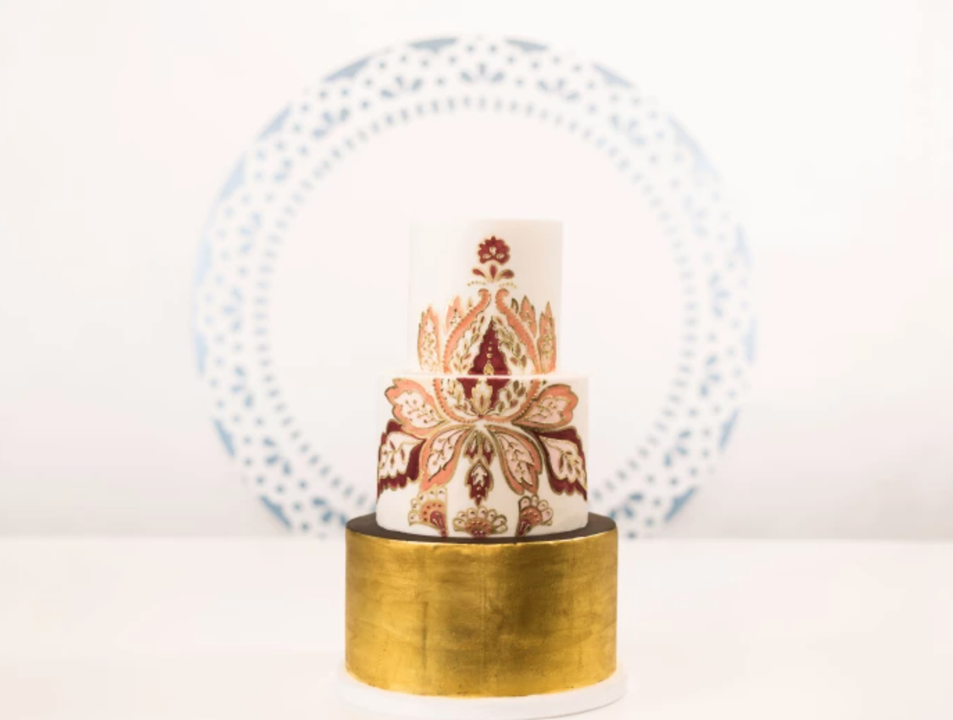 tiered cake with gold leaf base