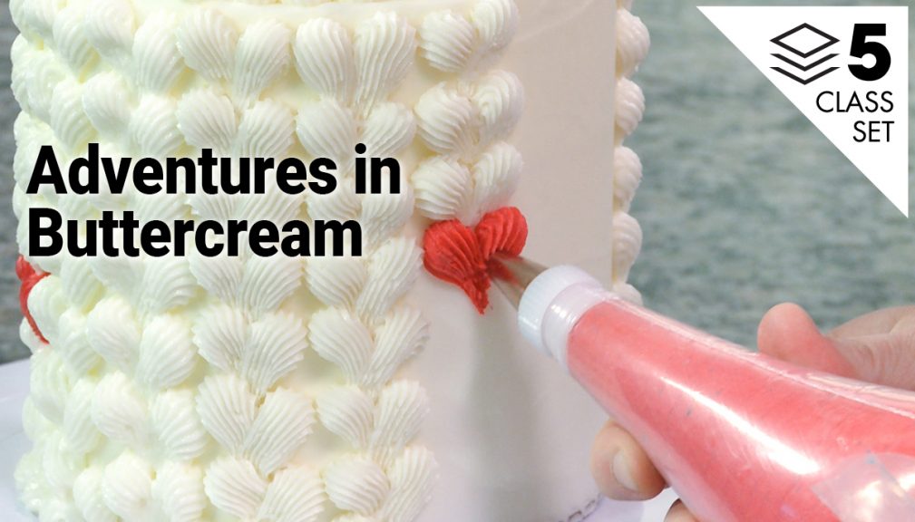 Piping buttercream hearts onto a cake