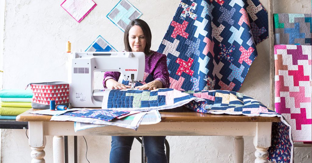 Woman sewing a quilt