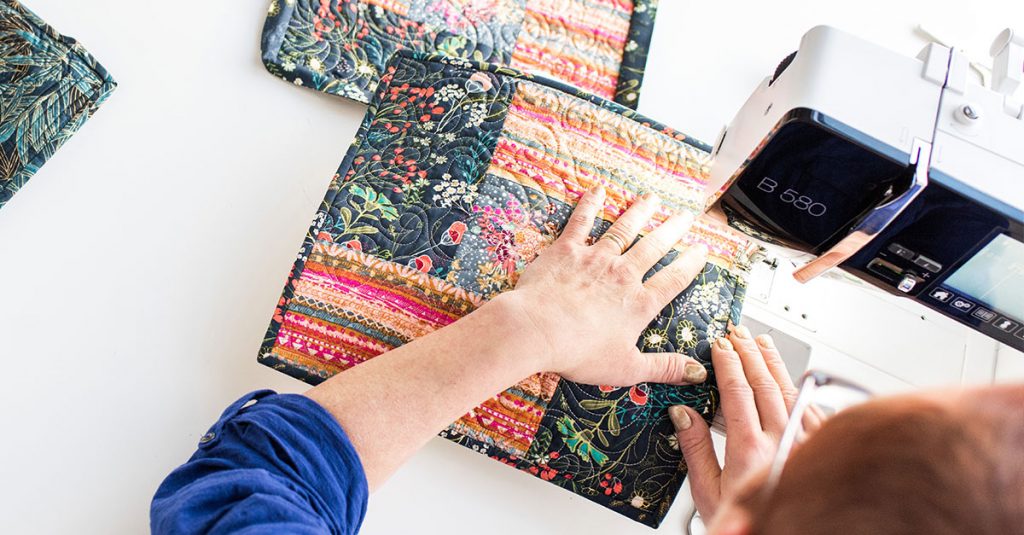 Person sewing a quilt block