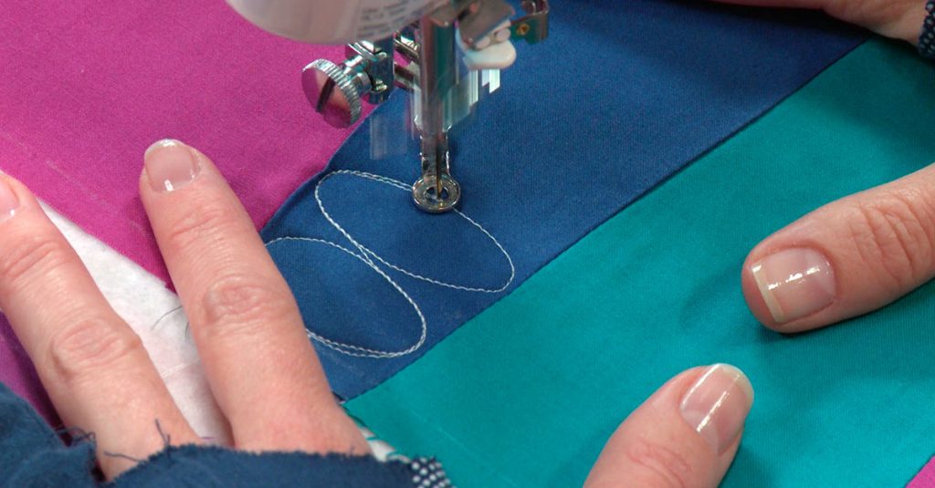 Quilting ovals on blue fabric