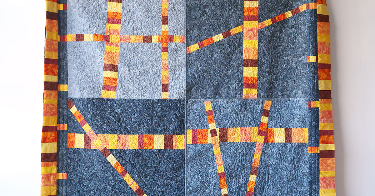 Scrappy stripe sectioned quilt