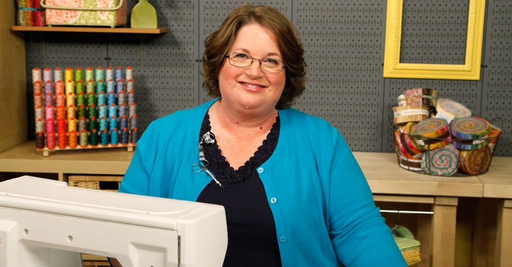 Woman with a sewing machine smiling
