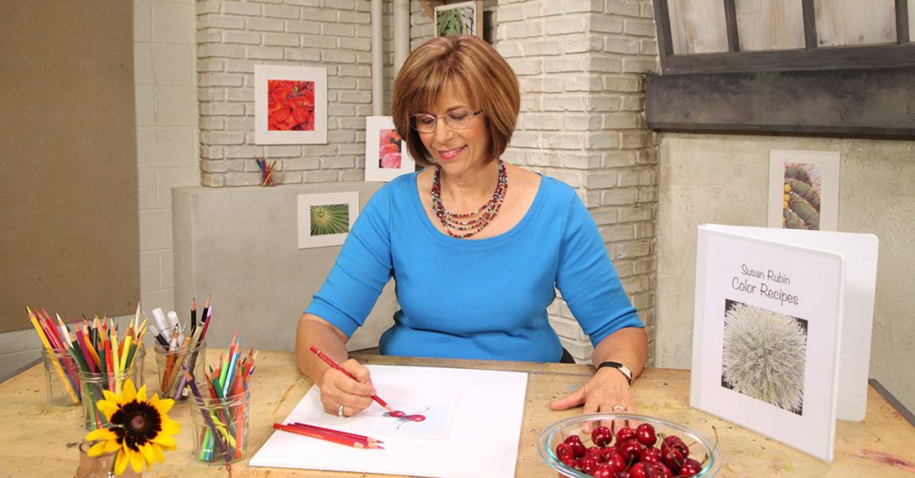 Woman drawing with a red colored pencil