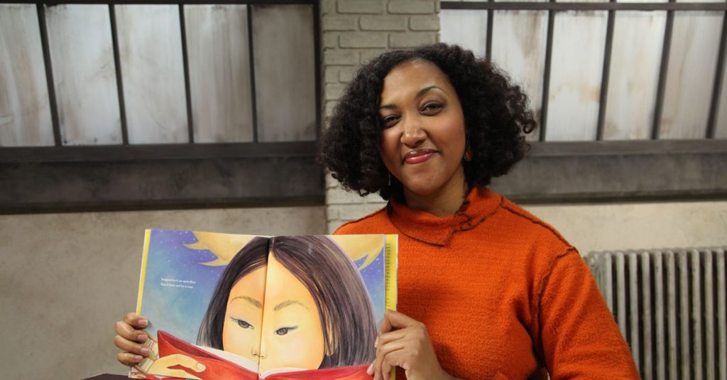 Woman holding open a picture book