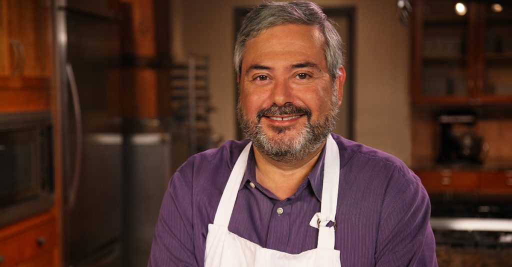 Man in an apron looking at the camera