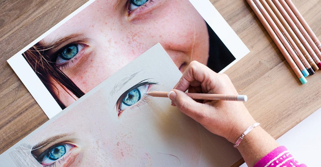Woman drawing realistic eyes