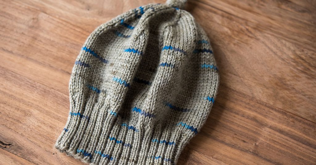 Knit grey hard with blue accents