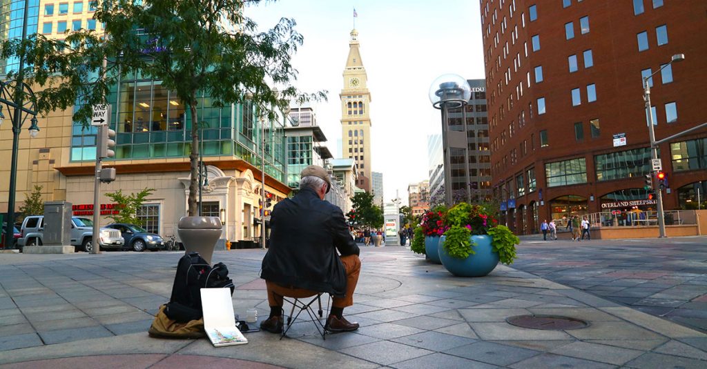Man sitting outside in a city