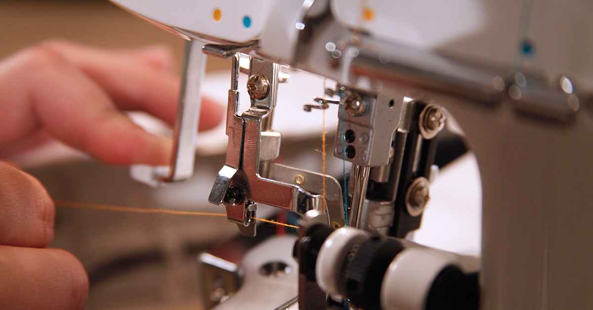 Close up of orange thread through a machine