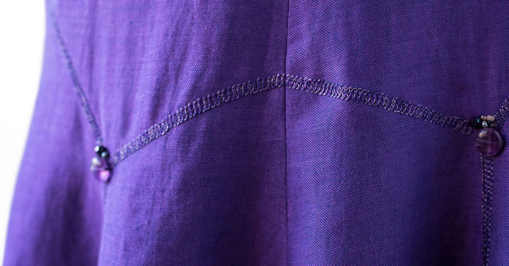 Stitching along purple fabric