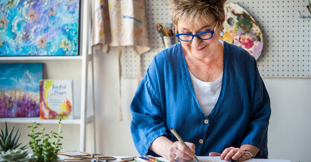Woman drawing with a black pen