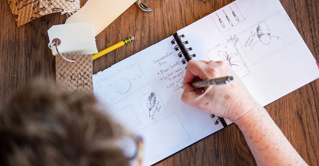 Person writing in a sketch book