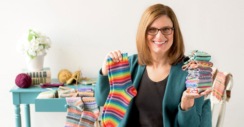 Woman holding up colorful socks