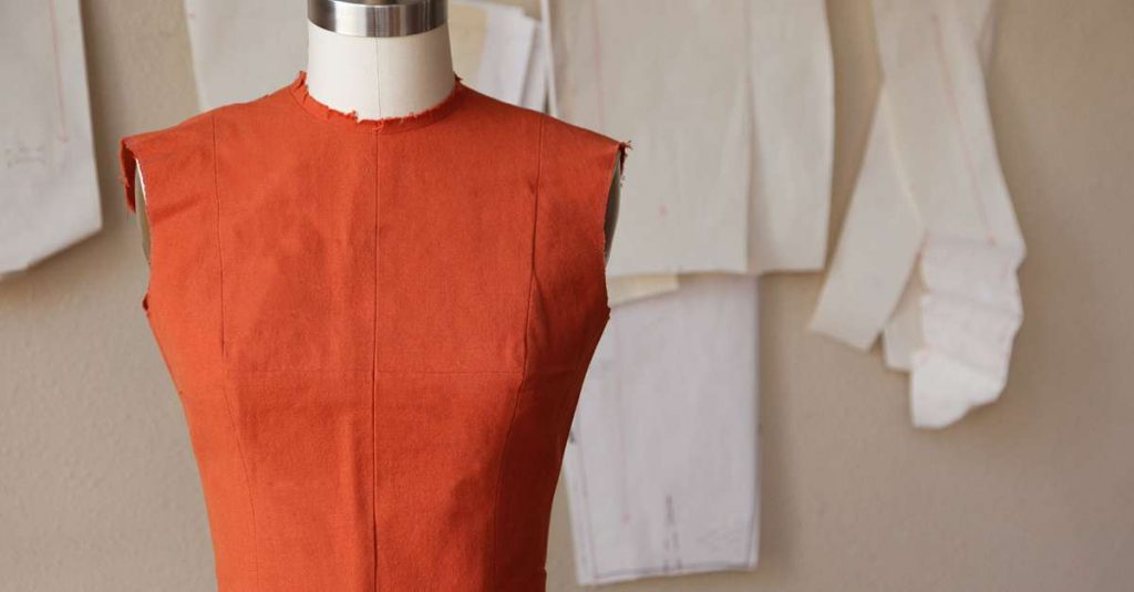 Rust color sleeveless top on a form
