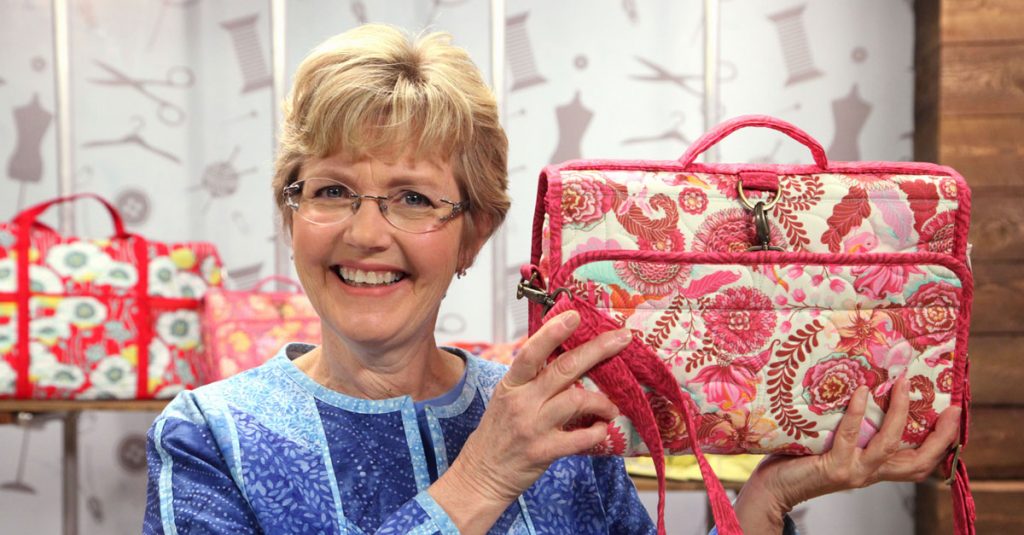 Woman holding up a patterned bag