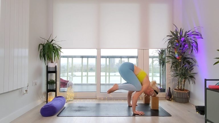 Person doing crow position with yoga blocks