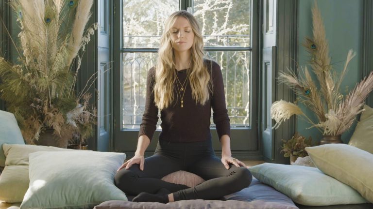 Woman in a yoga seated position with her eyes closed