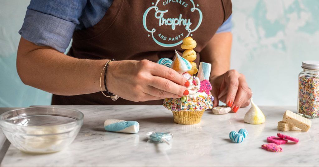 Placing cupcake topper on a cupcake